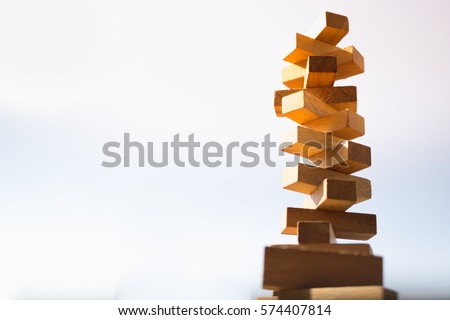 The tower stack from wooden blocks toy with sky background. Learning and development concept.