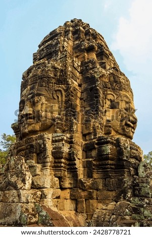 Tower with two of the 216 smiling sandstone faces at 12th century bayon temple in angkor thom walled city, angkor, unesco world heritage site, siem reap, cambodia, indochina, southeast asia, asia