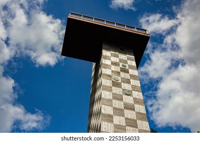 Tower with viewing platform shot from below with a cloudy sky in the background