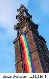 The Tower Of The Westerkerk Church (Westertoren), Built Between 1620 And 1631, Decorated With A Giant Rainbow Banner During LGBTI Pride In Amsterdam, Holland, In The Summer Of 2018. 