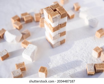 A Tower Of White And Brown Sugar Cubes. Sweet Food Ingredient Concept.