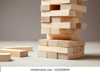 Tower Of Wooden Blocks On Gray Background. Board Game For The Whole Family Or Party. Concept Of Building Business Or Building Team. Copy Space For Text