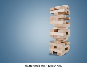 Tower of wooden cubes from table game over grey background - Shutterstock ID 1238547109
