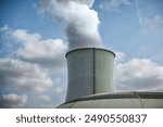 Towering Cooling Towers at Power Plant with Steam Plumes