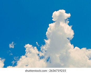 Towering cumulus cloud under clear sky