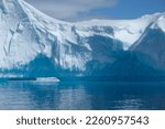 Towering Glacier Iceberg Ice structure in antarctica with well defined abstract shape in the sunny but snowy sky