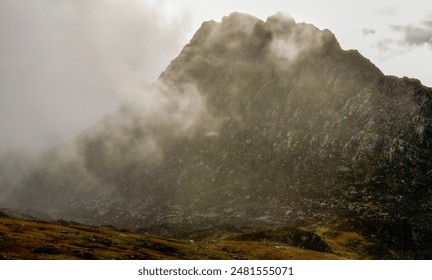 A towering mountain surrounded by clouds. Wales, UK
