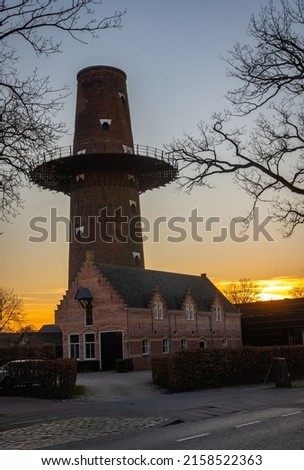 Towering ruin of historical dutch windmill by the sunset in the city of Breda, Province North Brabant
