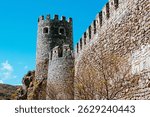 The towering stone fortifications of Rabati Castle in Akhaltsikhe, Georgia, showcase the strength and resilience of medieval architecture. The cylindrical towers and crenellated walls.