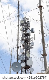 Towers and a dense array of cellular, radio, and satellite antennas, providing communication, internet, and broadcast services