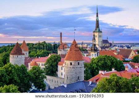 Towers and red tiled roofs of Tallinn city's Old town on sunset, Estonia