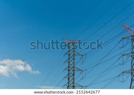 Towers that transmit high voltage. Energy transferred from cables. Electric bills background