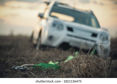 Towing Hook With A Rope And Car Stuck In The Mud .