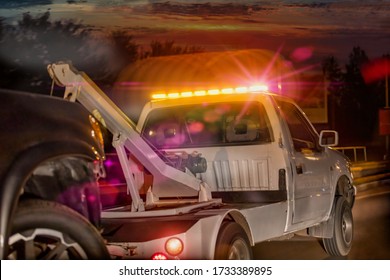 Towing truck on the move at  night with the lights and siren on