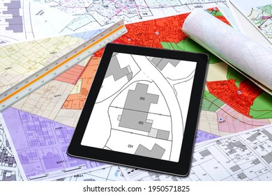 Town Planning And Land Use Planning - Digital Tablet Displaying A Cadastral Plan, Placed On Local Town Planning Plan Maps 