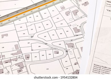 Town Planning And Land Use Planning - Printed Map Of A Cadastral Plan On Which A Measuring Ruler Is Placed