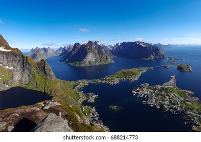 The town Reine and  its surrounding fjords in Lofoten, Norway, seen from top of the mountain Reinebringen on a nice clear day.
