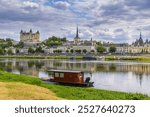 Town of Saumur, France, located at the Loire river under a beautiful cloudscape during daytime.