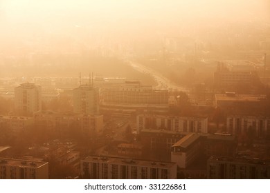 Town With Twilight Glowing In Smoky Air