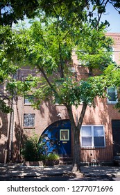 Town-homes In An Urban Area On A Street Lined With Trees. The Urban Tree Canopy Provides Shade For The Homes On This Street. 