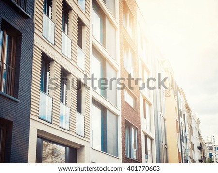 Similar – Apartment building with balconies and orange brick walls