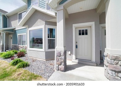 Townhouse Exterior With White Front Door And Bay Windows