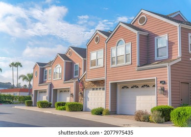 Townhouses Exterior With Pink Vinyl Wood And Stone Veneer Sidings At Southern California