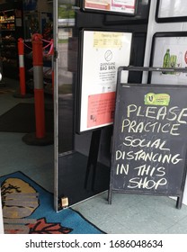 
TOWNSVILLE, AUSTRALIA - March 28, 2020. Coronavirus Pandemic. Corner Store In Suburb Of Stuart, Displaying Requesting Social Distancing In Store.
