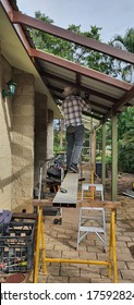 Townsville, Queensland, Australia - June 2020:  Retiree Painting Verandah Roof Panels