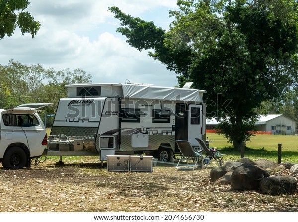 Townsville,\
Queensland, Australia - November 2021: Caravan towed by off road\
vehicle parked in free camp for the\
night