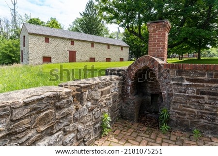Towson, Maryland -2022: Hampton National Historic Site. Long House Granary and outdoor fireplace. The two-story stone structure served as a hog barn and granary through the historic period. 