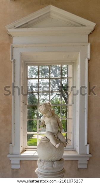 Towson, Maryland -2022: Hampton National\
Historic Site. Cherub statue on portico at Hampton Mansion. \