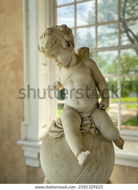 Towson, Maryland -2022: Hampton National
Historic Site. Cherub statue on portico at Hampton Mansion. 