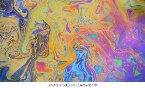 Toxic colours of oil and water in a chemical spill creating a psychedelic blur of rainbow colours. Copyspace area for environmental and pollution based themes and designs.