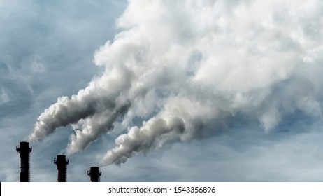 Toxic emissions of toxic gases into the atmosphere, industrial air pollution. Problems of the environment and ecology. Dark chimneys blowing huge billows of smoke into the sky