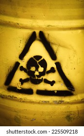Toxic waste symbol on a yellow barrel.