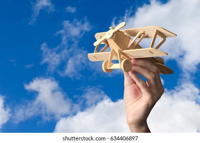 Toy airplane in hand - a symbol of travel and dreams - Shutterstock ID 634406897