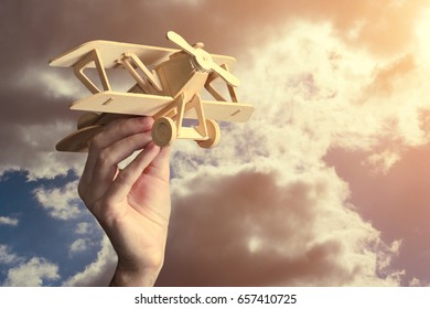 Toy airplane in hand - a symbol of travel and dreams. Instagram effect, toned photo filter - Shutterstock ID 657410725