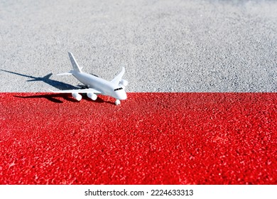 Toy airplane placed on the road painted the colors of the national flag of Poland. - Powered by Shutterstock