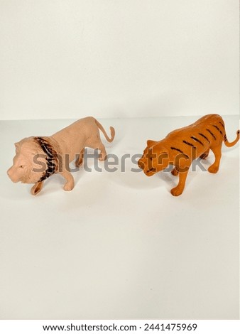 Toy animal figure lion and tiger on white