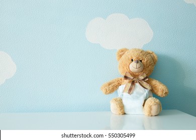 Toy bear dressed in diaper - Shutterstock ID 550305499
