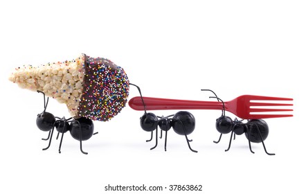 Toy black ants carrying a cereal treat ice cream cone and a fork, concept, isolated on white background, horizontal with copy space