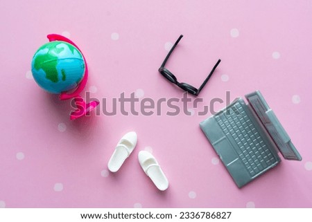 Toy black glasses, white boots, laptop and globe close-up. Back to school concept. High quality photo