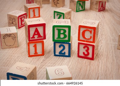Toy blocks spelling out "ABC 123" 