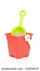 A Toy Bucket And Spade With Sand On A White Background