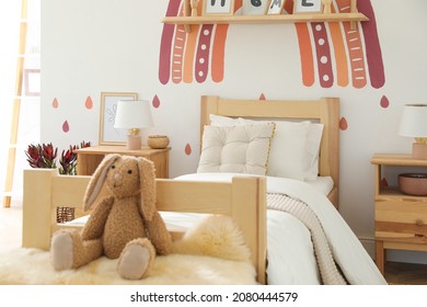 Toy Bunny On Faux Fur In Modern Girl's Bedroom. Interior Design