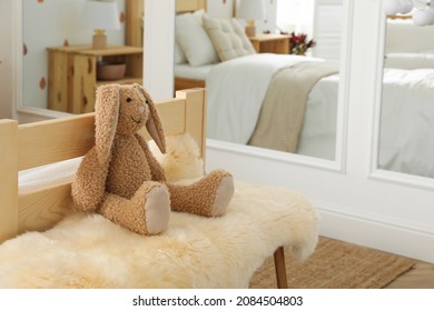 Toy Bunny On Faux Fur In Modern Girl's Bedroom. Interior Design