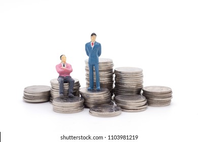 Toy Businessman And Coins On White Background