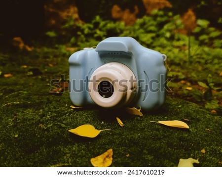 A toy camera lying in the ground with leaves around it Stock photo © 