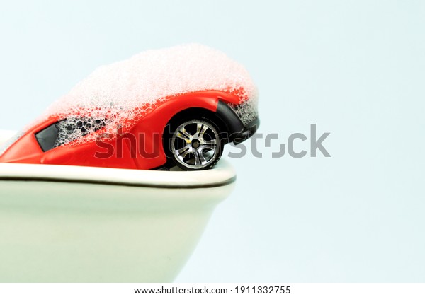 toy car in a\
bubble bath, car wash\
concept